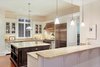 Modern home with Kitchen, Dark Hardwood Floor, Dishwasher, Marble Counter, Pendant Lighting, White Cabinet, Range Hood, Refrigerator, Drop In Sink, Ceiling Lighting, Range, and Stone Tile Backsplashe. Kitchen Photo 7 of Spice Bay