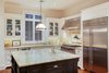 Modern home with Kitchen, Stone Tile Backsplashe, Drop In Sink, Ceiling Lighting, Range, White Cabinet, Pendant Lighting, Dark Hardwood Floor, Granite Counter, Range Hood, and Refrigerator. Kitchen Photo 8 of Spice Bay
