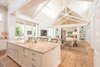 Modern home with Living Room, Pendant Lighting, Chair, Sofa, Coffee Tables, Light Hardwood Floor, and Ceiling Lighting. Kitchen Island and Living Area Photo 3 of Venice Beach Cottage