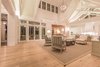 Modern home with Living Room, Light Hardwood Floor, Accent Lighting, Sofa, Ceiling Lighting, Pendant Lighting, Coffee Tables, and Chair. Living Room into kitchen Photo 9 of Venice Beach Cottage
