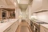 Modern home with Kitchen, Ceiling Lighting, Range, Light Hardwood Floor, Marble Counter, Range Hood, White Cabinet, Subway Tile Backsplashe, and Drop In Sink. Kitchen into pantry area and dining Photo 6 of Venice Beach Cottage