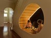 Modern home with Kids Room. A uniquely shaped, well-lit nook under the stairs of the Peas in a Pod residence provides an imaginative space for play. CplusC Architectural Workshop designed much of the space around the clients four children's needs. Photo 8 of Peas In A Pod