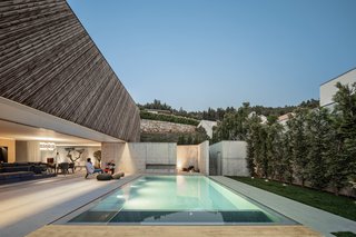 Indoor/outdoor living is sweet at Casa A by REM'A Arquitectos: residents can easily step from the sleek concrete interiors to enjoy the pool and backyard area, which are framed by hillside views.