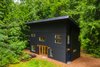 Modern home with Exterior, Metal Roof Material, Shed RoofLine, Metal Siding Material, and House Building Type. Simple shed roof design with steel siding gives the home texture. Photo of Guemes Island Home