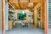Modern home with Dining Room, Chair, Ceiling Lighting, Concrete Floor, Table, Shelves, and Pendant Lighting. Expansive doors open the the kitchen up to the forest on two sides. Photo 8 of Guemes Island Home