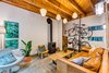 Modern home with Concrete Floor, Chair, and Pendant Lighting. The living room, located just steps away from the kitchen, offers ample seating. The leather couch, wood furniture, and polished concrete floors allow for easy cleaning. Photo 11 of Guemes Island Home