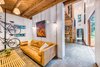 Leather couch, twin wall interior walls, wood furniture, polished concrete floors allow for easy cleaning. Photo 6 of Guemes Island Home modern home