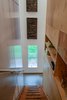 A fir beam stairway leads to the second floor. Open shelving provides additional storage. Photo 13 of Guemes Island Home modern home