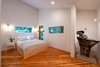Modern home with Ceiling Lighting and Storage. Main bedroom with custom set windows to join the forest with the room. Photo 14 of Guemes Island Home