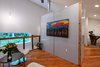 Modern home with Ceiling Lighting, Pendant Lighting, and Chair. Open loft area for reading or movie watching. Movie screen is behind the artwork. Photo 17 of Guemes Island Home