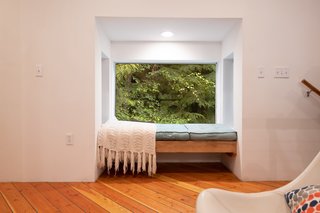 A pop-out nook on the second floor provides a cozy place to curl up with a book.