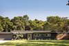 Modern home with Exterior, Flat RoofLine, Wood Siding Material, Mid-Century Building Type, and House Building Type. Front of home Photo of The Leichler