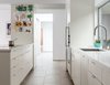 Modern home with Kitchen, Engineered Quartz Counter, White Cabinet, Cooktops, Wall Oven, Wood Cabinet, Ceiling Lighting, Porcelain Tile Floor, and Undermount Sink. Kitchen Photo 2 of The Leichler