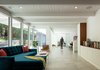 Modern home with Living Room, Coffee Tables, Shelves, Sectional, Porcelain Tile Floor, Storage, Ceiling Lighting, Sofa, and Chair. Living room to study Photo 3 of The Leichler