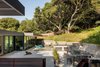 Modern home with Outdoor, Decomposed Granite Patio, Porch, Deck, Large Patio, Porch, Deck, Raised Planters, Trees, Concrete Fences, Wall, Retaining Fences, Wall, Horizontal Fences, Wall, Tile Patio, Porch, Deck, Wood Fences, Wall, Slope, and Back Yard. Backyard Photo 9 of The Leichler