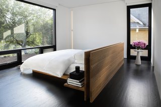 The bed in the master bedroom was designed in-house by Messana O'Rorke.