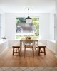 Modern home with Dining Room, Bench, Ceiling Lighting, Table, Chair, Pendant Lighting, and Light Hardwood Floor. View of Dining Area to Backyard: The New Old Light by Kimu Design hangs in the foreground. Photo of The New Old