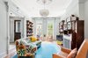 Modern home with Living Room, Wood Burning Fireplace, Pendant Lighting, Sofa, and Chair. Seating area centered around a working marble and wood fireplace. Photo of A Bedford-Stuyvesant home that celebrates lifestyle