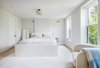 Modern home with Bedroom, Bed, Ceiling Lighting, Light Hardwood Floor, and Chair. Master bedroom Photo 8 of A Bedford-Stuyvesant home that celebrates lifestyle