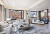 Modern home with Living Room, Lamps, Sofa, Recliner, Coffee Tables, and End Tables. A wall of sliding glass doors off the living room lead to a generous northern terrace for BBQs, al fresco dining and summer cocktail parties. Photo 4 of A Brooklyn Penthouse With Three Terraces