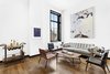 Modern home with Living Room, Chair, End Tables, Coffee Tables, Medium Hardwood Floor, and Sofa. Beautifully designed with many Danish inspired pieces, the unit can be delivered fully furnished. Photo of Expansive Pre-War Architecture Meets Stylish and Modern Living