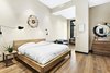 Modern home with Bedroom, Night Stands, Bed, Dresser, Medium Hardwood Floor, and Wall Lighting. The generous master suite contains an alcove perfect for a home office, entertainment space or nursery. Photo 5 of Expansive Pre-War Architecture Meets Stylish and Modern Living