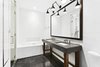 Modern home with Bath Room, Drop In Sink, Enclosed Shower, Wall Lighting, Marble Counter, Soaking Tub, and Marble Floor. The spectacular en-suite bathroom has custom marble floors, a soaking tub, glass enclosed shower, marble slab double vanity and is decorated with some of Waterworks finest fixtures. Photo 6 of Expansive Pre-War Architecture Meets Stylish and Modern Living