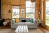 Modern home with Living Room, Ottomans, Ceiling Lighting, Wood Burning Fireplace, Pendant Lighting, Sofa, End Tables, and Medium Hardwood Floor. Our couch folds out into a queen size sleeper bed for extra guests. Photo 2 of Off Grid Cabin in the Texas Hill Country