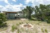 Backyard has a fire pit and a hammock, perfect for stargazing! Photo 11 of Off Grid Cabin in the Texas Hill Country modern home