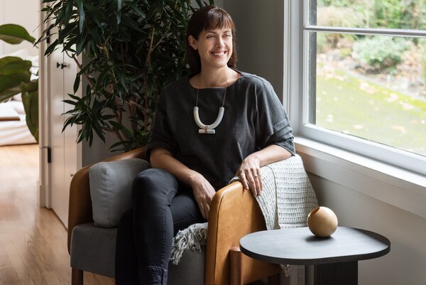 Architect Michelle Linden, co-owner and principal designer of Atelier Drome, sits in a leather armchair from Mexico City studio