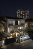 The porous east facade at night Photo 8 of Cascading House modern home