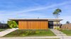 Modern home with Exterior and House Building Type. It is known that the proper site of a house in the lot, regarding the sun, is a vital decision in order to enable the thermal comfort of the project. That is the reason why the yard, project site protagonist, opens itself southeast, the rooms are facing the northeast and the living room volume, also southeast directed, helps to cast a shadow in part of the yard as the sun goes down. The site is distributed in a U-shape, sectoring different uses to each volume: service, social and familiar. This last one is 1 meter above the house level and grants even more privacy to the bedrooms. Photo 3 of Patio House