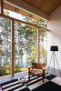 Modern home with Living Room, Concrete Floor, Chair, Wood Burning Fireplace, and Floor Lighting. Sooke 01- Interior Photo 9 of Sooke 01 House