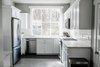 Modern home with Kitchen, White Cabinet, Refrigerator, Subway Tile Backsplashe, Wood Cabinet, Engineered Quartz Counter, Cooktops, Microwave, Dishwasher, Range, and Undermount Sink. Kitchen Photo 5 of Secret Garden