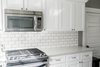 Modern home with Kitchen, Microwave, Range, Subway Tile Backsplashe, White Cabinet, Engineered Quartz Counter, and Wood Cabinet. Kitchen Photo 7 of Secret Garden