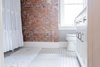 Modern home with Bath Room, Porcelain Tile Floor, Marble Counter, Two Piece Toilet, and Freestanding Tub. Bathroom Photo 9 of Secret Garden