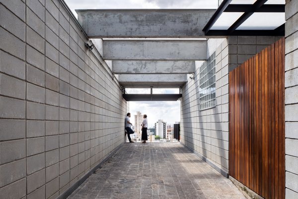 The pergola on the "promenade" entrance to the upper level residence frames views of the city and hints at the expansive balcony through which the home is entered.