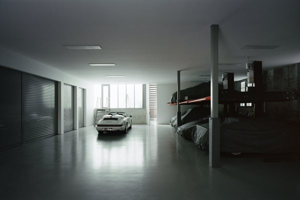 The garage—a clean and well-lit space with an epoxy floor—takes inspiration from Formula One pits. It can accommodate 10 cars—eight on four two-car stackers, plus spaces for the family car and a racing car.