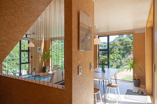 Large windows frame views of the surrounding bush, inviting the landscape inside.