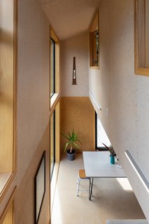 Above a height of 2.4 meters, the internal walls have been whitewashed. This, along with the double-height void above the living room, helps to give the small home a voluminous feeling.