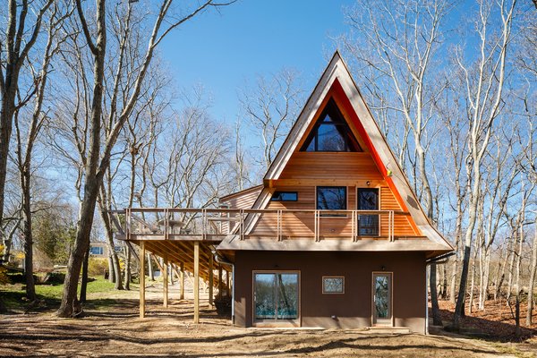 The lower "basement" level sits beneath the main level of the home and is accessible from doors at the rear, and from an internal stair. The original deck was replaced by one that visually extends the new entry footbridge around the home.