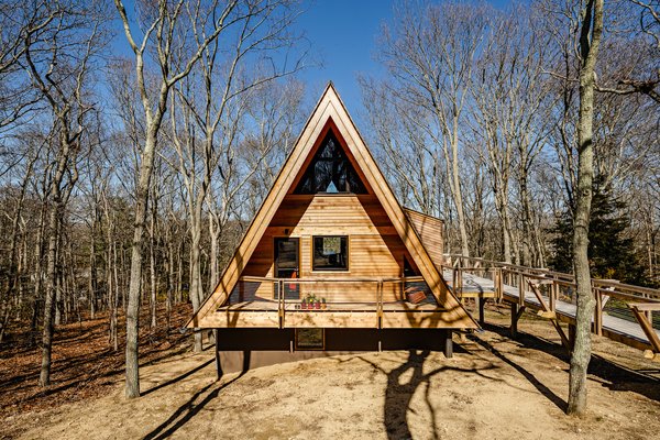 The triangular form of the 1,189-square-foot A-frame cabin, which sits in a small forest of oak trees on Long Island, has been emphasized as part of the renovation.