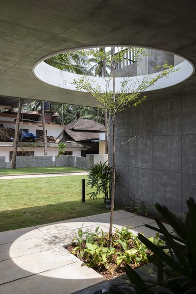 The circular openings in the concrete slabs allow plants to grow through the building, strengthening the home’s connection with the site. As the plants grow, the light will become filtered. 