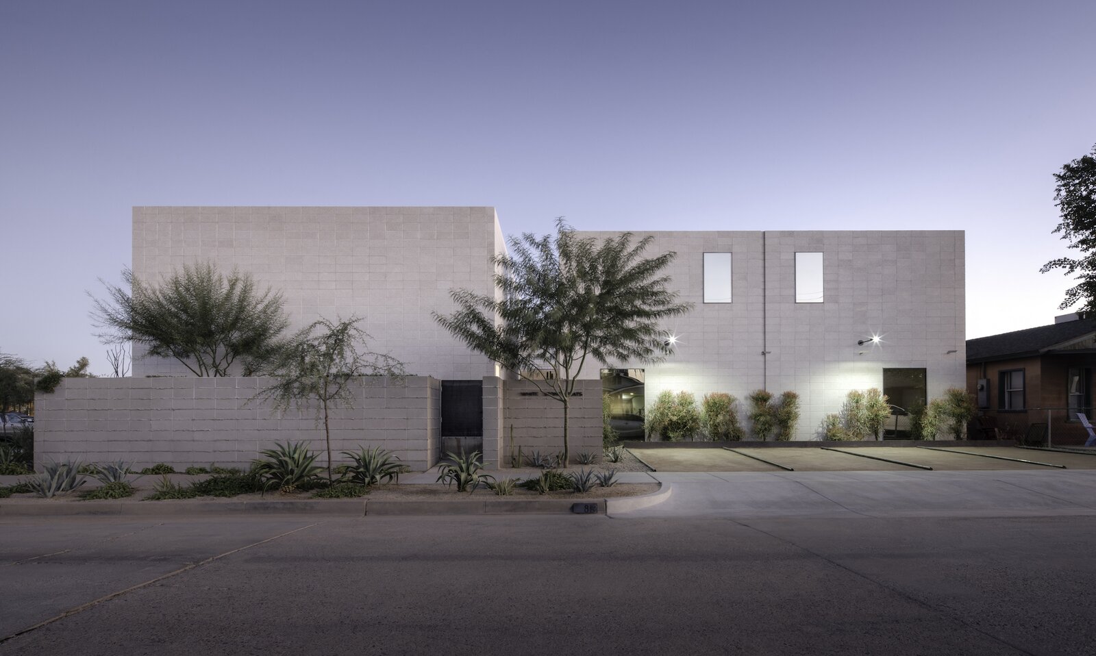 "The ‘sugar cube’ like volumes of the complex allows the architecture to frame the historic home to the north and the seamless mirrored glass windows reflect the surrounding context onto the building facade," says designer Benjamin Hall. "It's sort of acting like a canvas for the context."