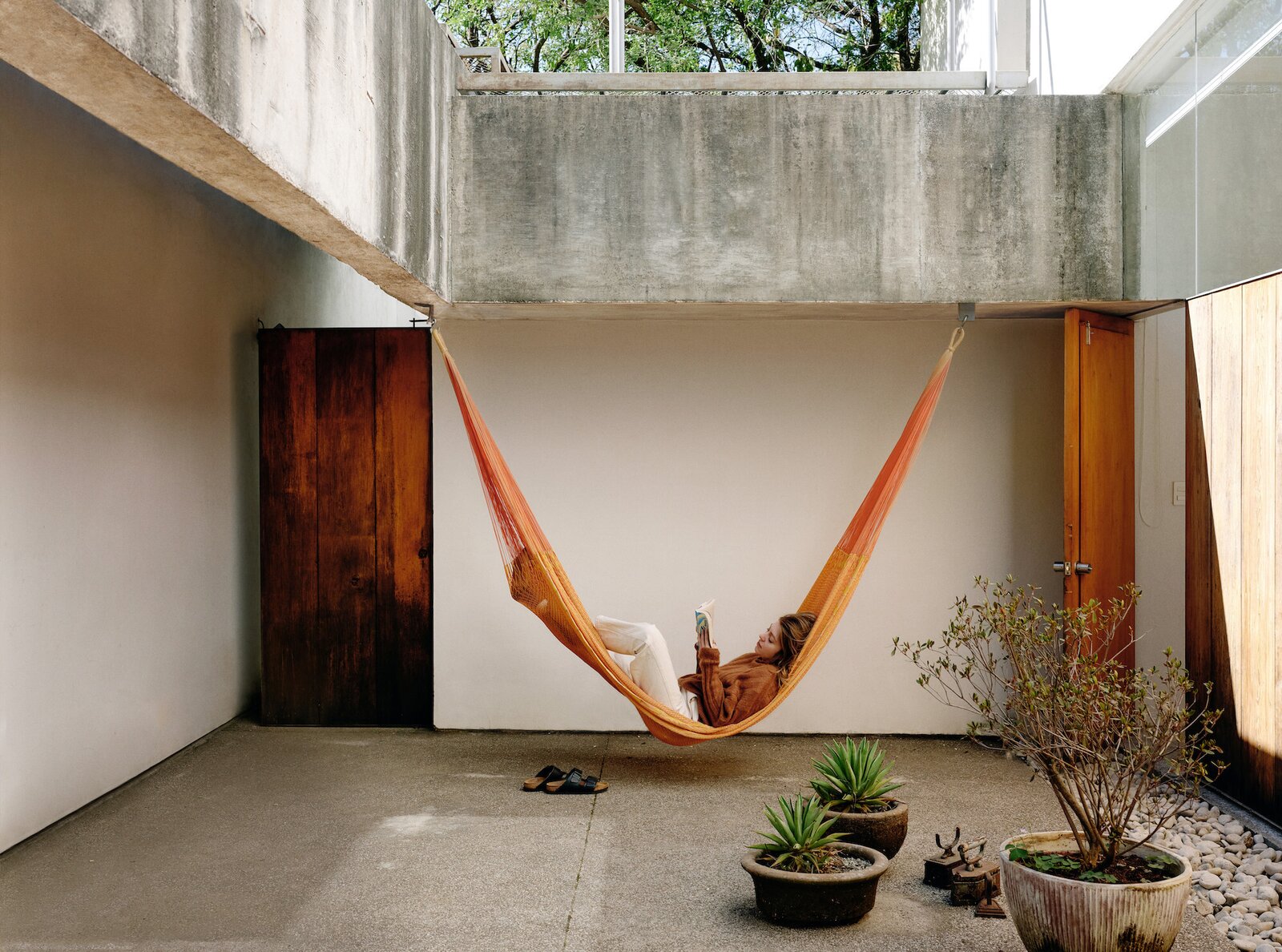 This home in Morelos, Mexico, is nestled in a sub-tropical rainforest and features a relaxed internal courtyard furnished with hammocks.