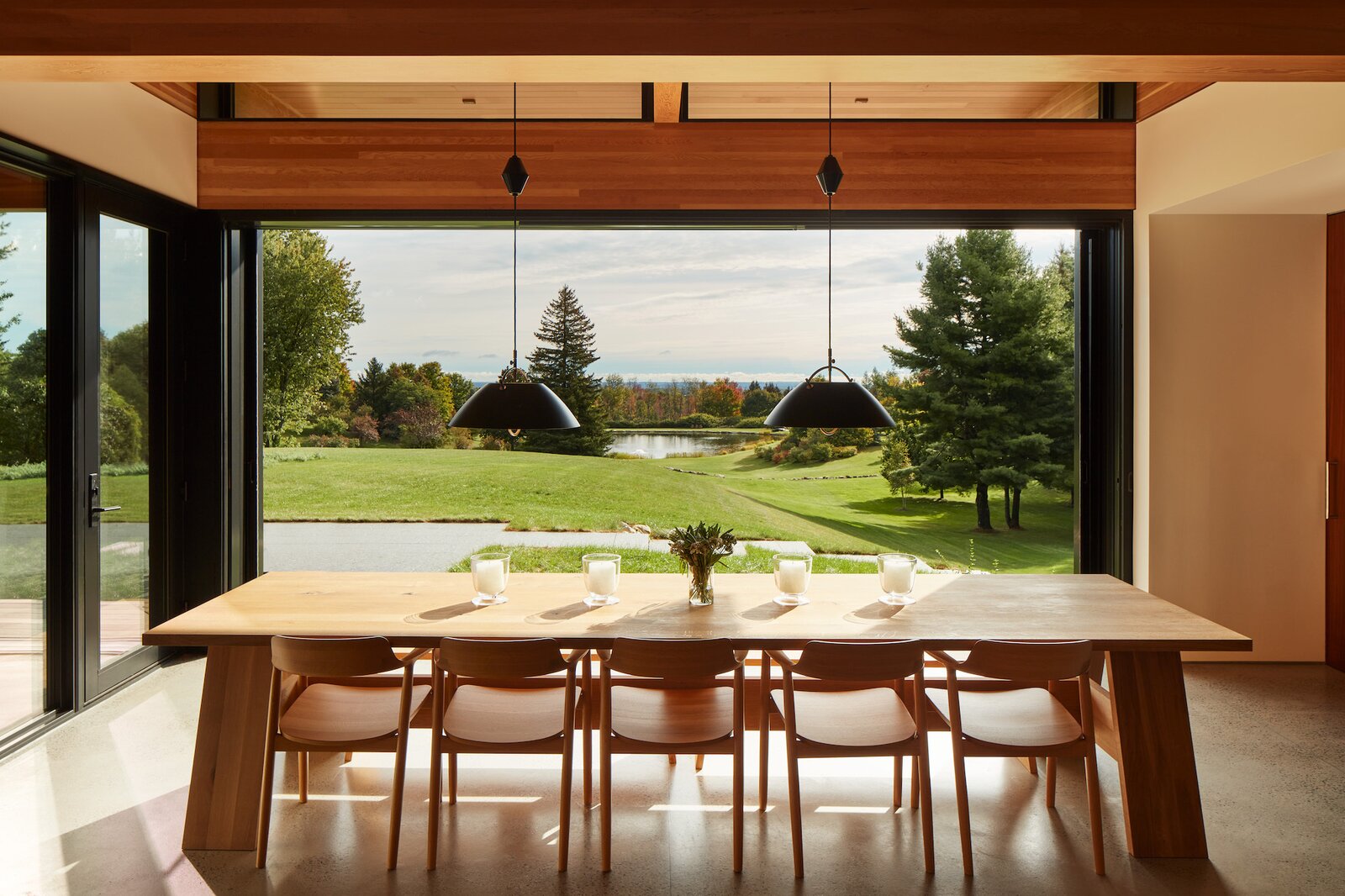 Every room in the home enjoys views of the landscape—including the dining area. The natural material palette of the interior emphasizes this connection between inside and out.