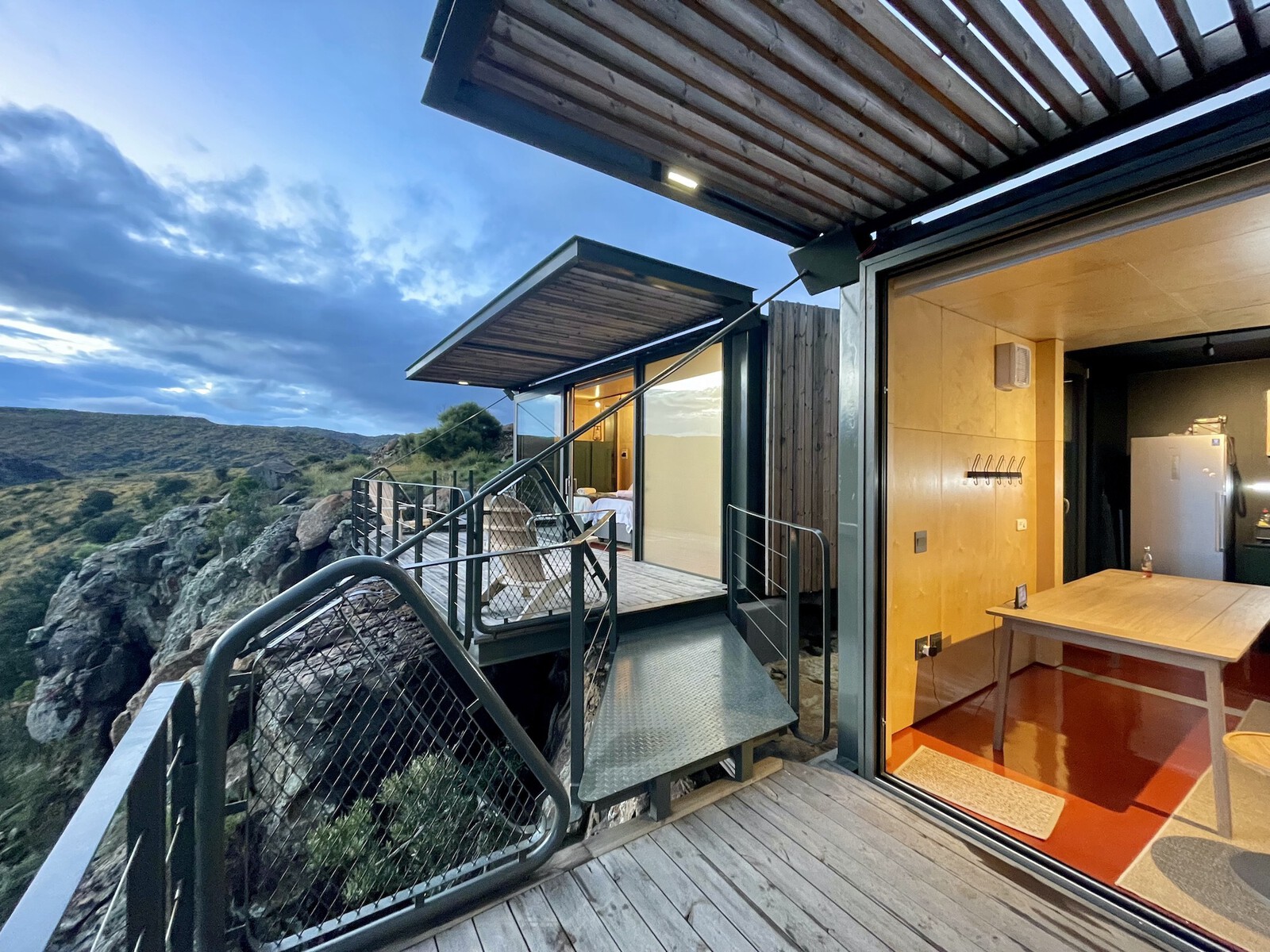 The decks and pergolas are attached to the shipping containers and were folded around the modules during transport—an approached that informed the way the modules look. 