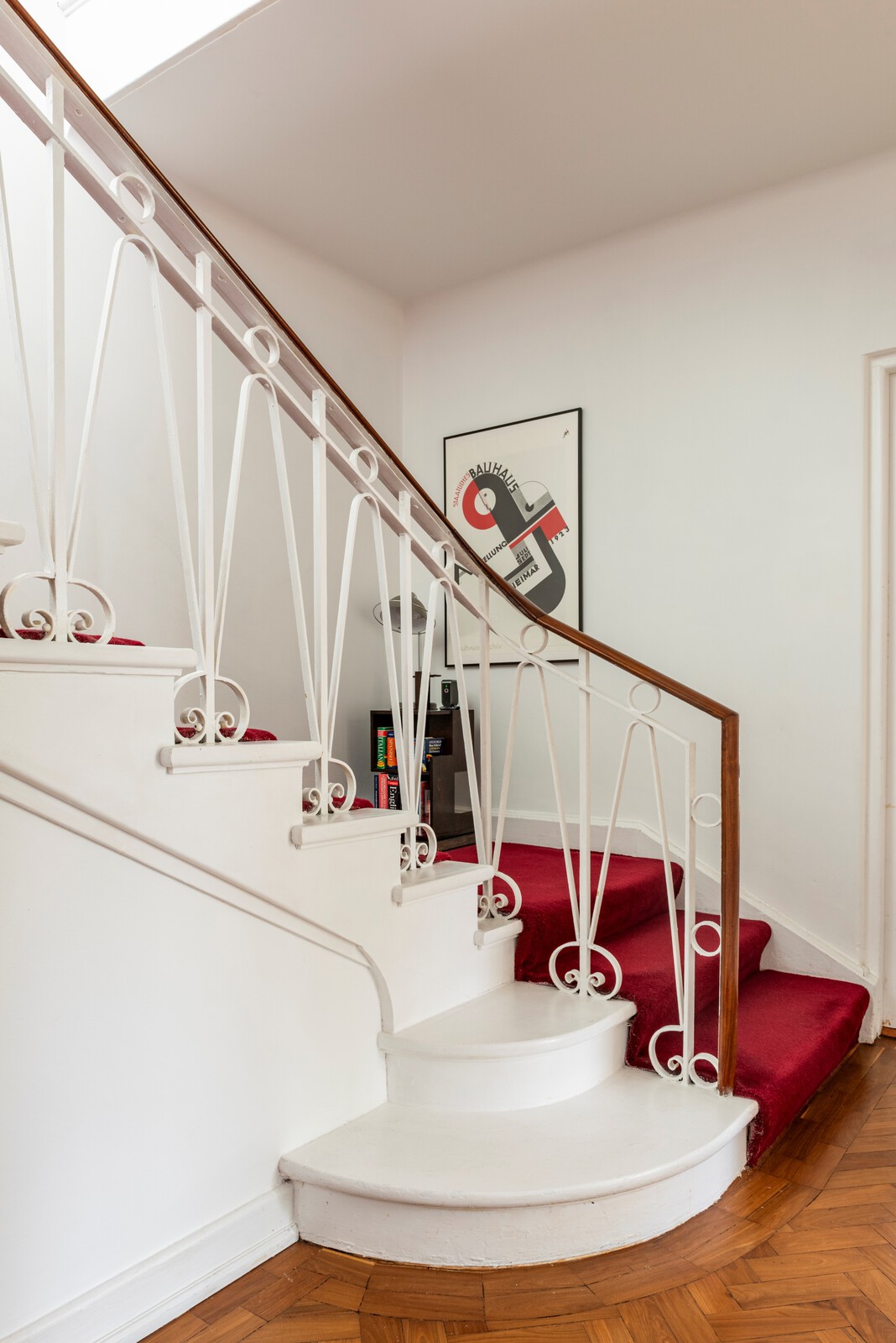 The stair features an original ironwork balustrade.