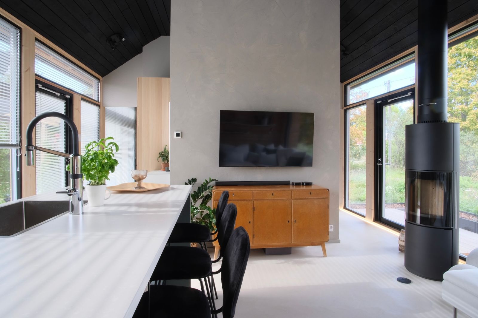 While the house is prefab, the interior and finishes are almost entirely designed by Jussi-Pekka. One of his favorite custom-made elements is an LED light he designed for the window wall on the view side—an idea inspired by the lighting strips in planes that guide to emergency exits. "It’s there to highlight the importance of the glass wall that faces one of the most important aspects of the house: the view,