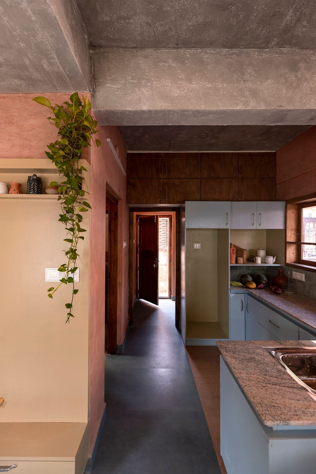 A muted color palette—think soft blues, ochres, and pale yellows—that complements the mud finishes, exposed brick, and bare concrete was used to define spaces and brighten daily life. 